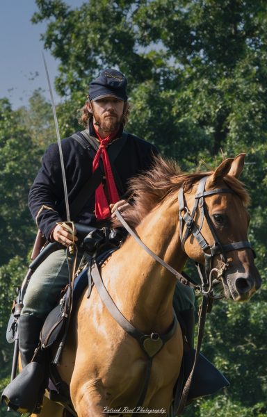 A cavalry soldier on horseback, wielding a saber with confidence. Dressed in a military uniform, the soldier's posture is dynamic as they prepare to charge, embodying the valor and intensity of cavalry combat. The scene captures the spirit of bravery and skill associated with mounted soldiers.